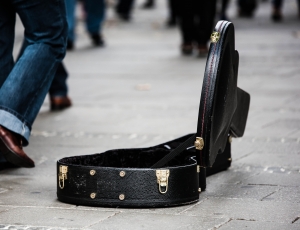 black leather guitar case on the streets thumbnail